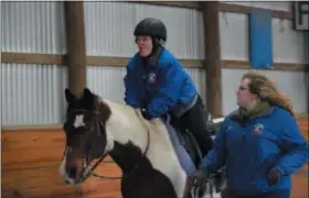  ?? MARIAN DENNIS — MEDIANEWS GROUP ?? Ann Minehart, 24, rides horse, Gunner through an obstacle course at Sebastian Riding Associates.