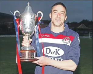  ??  ?? Oban Saints captain Marc MacCallum with the impressive Jimmy Marshall Cup.