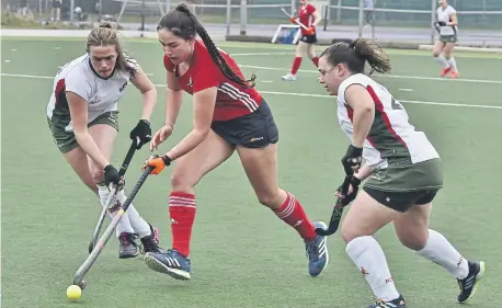  ?? ?? Eva Stones (red) in action for City of Peterborou­gh Ladies 2nds v Norwich Dragons. Photos; David Lowndes.
