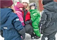  ?? ANDREA BRUCE/THE NEW YORK TIMES ?? Izabell Sandberg comforts students at the Seafarer’s Preschool in Stockholm. Science may still be divided over whether gender difference­s are rooted in biology or culture, but many of Sweden’s preschools are doing what they can to deconstruc­t them.