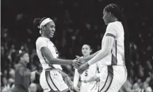  ?? JEFF BLAKE/USA TODAY SPORTS ?? South Carolina guard Bree Hall (23) and forward Sania Feagin (20) celebrate a play against North Carolina in the second half at Colonial Life Arena on Sunday.