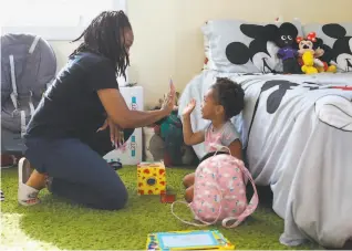  ?? Photos by Yalonda M. James / The Chronicle ?? Sharayah Alexander highfives daughter Savannah, 2. Alexander, of Vallejo, is involved in the Deliver Birth Justice campaign to reduce Black maternal and infant mortality.