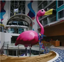  ?? Getty Images ?? A flamingo installati­on looms large over the family-friendly Surfside neighbourh­ood on the huge cruise ship