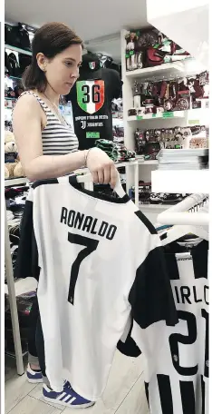  ?? ISABELLA BONOTTO/AFP/GETTY IMAGES ?? Cristiano Ronaldo’s Juventus jersey is already in stores and flying off the shelves in Turin, Italy.