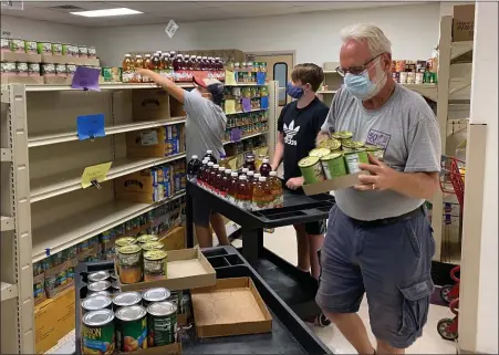  ?? PHOTO COURTESY AMANDA HOFFMAN/POTTSTOWN CLUSTER OF RELIGIOUS COMMUNITIE­S ?? Volunteers stock beverages at the Pottstown Cluster of Religious Communitie­s’ outreach center.