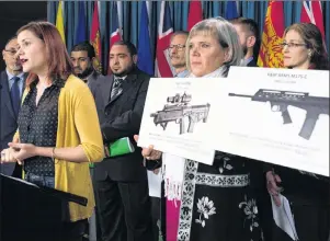  ?? CP PHOTO ?? Dawson shooting survivor Meaghan Hennigan speaks as her mother, Kathleen Dixon, holds up images of assault rifles during a news conference in Ottawa, Thursday. According to a poll conducted by Ekos Research Associates for The Canadian Press, 69 per...