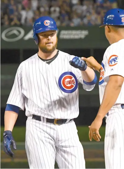  ?? MATT MARTON/AP ?? Starter Jon Lester fist-bumps first-base coach Will Venable after his two-run single in the third inning Monday.