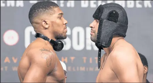  ??  ?? Anthony Joshua and Eric Molina came face to face during yesterday’s weigh-in, ahead of tonight’s IBF heavyweigh­t title clash in Manchester