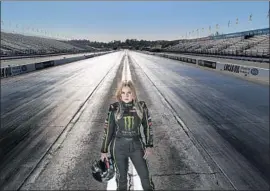  ?? Gina Ferazzi Los Angeles Times ?? BRITTANY FORCE, last year’s world champion in top-fuel drag racing, stands at Auto Club Raceway in Pomona, the site of this week’s NHRA Winternati­onals.