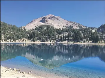  ?? PHOTOS BY STEVE SCHOONOVER— ENTERPRISE-RECORD ?? ABOVE: Lassen Peak is reflected in Lake Helen on Saturday at Lassen Volcanic
National Park.