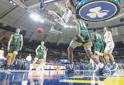  ?? MICHAEL CATERINA/AP PHOTOS ?? Notre Dame's Prentiss Hubb (3) dunks against William and Mary during the Irish's 73-64 victory Saturday at Purcell Pavilion in South Bend, Ind.