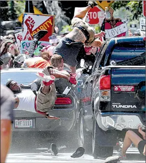  ?? AP/The Daily Progress/RYAN M. KELLY ?? A car sends people flying Saturday as it plows into a crowd after a protest against white nationalis­ts in Charlottes­ville, Va. The driver was arrested, officials said.