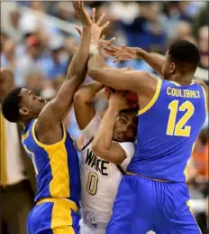  ?? Jared C. Tilton/Getty Images ?? Abdoul Karim Coulibaly, right, and Xavier Johnson double team Wake Forest’s Brandon Childress Tuesday in Greensboro, N.C.