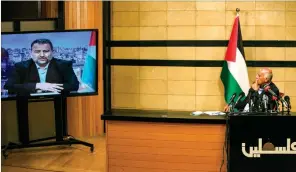  ?? (AFP) ?? Senior Fatah official Jibril Rajoub, in Ramallah, attends by video conference a meeting with deputy Hamas chief Saleh Arouri (on screen from Beirut) discussing Israel’s plan to annex parts of the Israeli-occupied West Bank on Thursday.