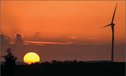  ?? (AP/Martin Meissner) ?? A wind turbine is seen Monday at sunset in Gelsenkirc­hen.