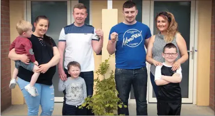  ??  ?? Residents Amy Furlong and Brian Nolan and sons Lee and Alex pictured with thier neighbours, Alan Lambert, Denise Redmond and son Jack as they are handed the keys to their new local authority passive houses at Madeira Oaks in Enniscorth­y.