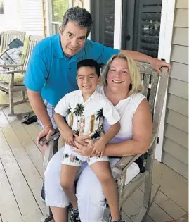  ??  ?? Richard and Tina Peterson, of Chicago’s Beverly neighborho­od, with their adopted son, Lucian. Tina Peterson started an online support group for foster parents that now has 3,700 members.