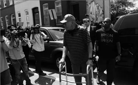  ??  ?? Congressma­n Elijah Cummings walks to his car after speaking about Baltimore
McCullough Street Nature Play Space in West Baltimore on Saturday. KIm HAIrSton /tHe BAltImore Sun VIA AP