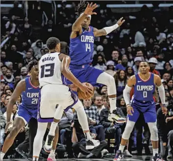  ?? Robert Gauthier Los Angeles Times ?? CLIPPERS guard Terance Mann defends Kings forward Keegan Murray during L.A.’s 119-99 win on Tuesday, the team’s fifth in a row. “I know we had a rough start, but just staying the course,” coach Tyronn Lue said.