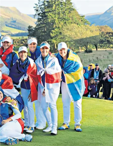  ??  ?? Flag-bearers: Europe’s players celebrate winning the Solheim Cup after a thrilling day of singles matches at Gleneagles