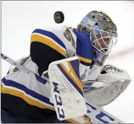  ?? Charles Krupa The Associated Press ?? Rookie goaltender Jordan Binnington makes one of his 32 saves in the Blues’ 4-1 Game 7 victory over the Bruins on Wednesday night.