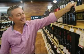  ??  ?? Blaine East, owner of P aradise Wine in Naples, carries the new U nity wines, designed to be more affordable and appeal to a younger generation.