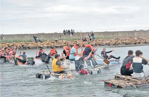  ??  ?? HAVING A SPLASHING TIME: A fun raft race that was organised at Rosehearty harbour to help boost the associatio­n’s fundraisin­g efforts