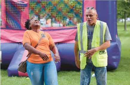  ?? TERRENCE ANTONIO JAMES/CHICAGO TRIBUNE ?? Tina Cooper, of Metropolit­an Peace Initiative­s, with Orlando Cintron, of anti-violence group Alliance of Local Service Organizati­ons, during “Light In the Night” event in Humboldt Park in Chicago, July 14, 2023.