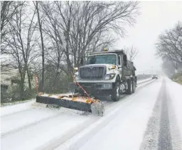  ?? PHOTOS BY JOHN MCCASLIN ?? Plowing Sperryvill­e Pike, a snowplow reaches Woodville during the height of the autumn snow and ice storm last Thursday.