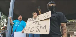  ?? GABRIELA CAMPOS/THE NEW MEXICAN ?? A small chorus of people, including Elena Ortiz, left, chanted ‘Abolish the Entrada!’ at a Plaza peace rally last week.