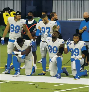  ?? ASHLEY LANDIS — THE ASSOCIATED PRESS ?? Members of the Rams stand and kneel during the national anthem before Sunday’s game in Inglewood.