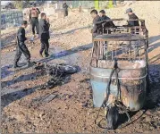  ?? MOHAMMAD ANWAR DANISHYAR / AP ?? Afghan security forces inspect the site of a bombing in Jalalabad province, east of Kabul, Afghanista­n, on Sunday. At least 15 people were killed and more than a dozen others wounded.