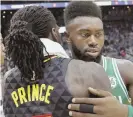  ?? AP PHOTO ?? IN SUPPORT: Jaylen Brown gets a hug and perhaps words of consolatio­n from Atlanta’s Taurean Prince after last night’s game.