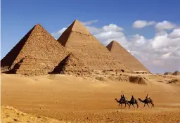  ??  ?? WONDER WALLS: A camel train and the pyramids of Egypt