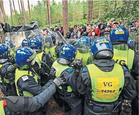  ??  ?? Police attempt to break up a suspected rave in Thetford Forest, Norfolk, where up to 500 people had gathered. It came after officers gained new powers to fine organisers of illegal gatherings up to £10,000, with attendees liable for a £100 fine, in a crackdown on those breaching Covid-19 restrictio­ns. The first of the fines were issued at the weekend.