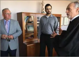  ?? RICHARD PAYERCHIN — THE MORNING JOURNAL ?? Lorain Port Authority board member Matthew Kusznir, center, and Lorain Port Authority Executive Director Tom Brown, left, listen to Lorain Municipal Judge Thomas Elwell after Kusznir was sworn in May 8. Kusznir was appointed by Lorain Mayor Chase...