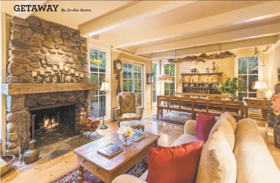  ?? Photograph­y by Paul Rollins ?? Above: A stone fireplace warms the combinatio­n living/dining room with a beamed ceiling and wide-plank hardwood floors. Below left: The Glen Ellen home includes an office with custom shelving. Below right: This covered patio offers an idyllic spot for...