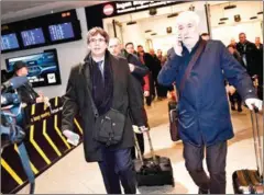  ?? TARIQ MIKKEL KHAN/SCANPIX/AFP ?? Former Catalan leader Carles Puigdemont (left) arrives yesterday at Copenhagen Airport in Denmark.