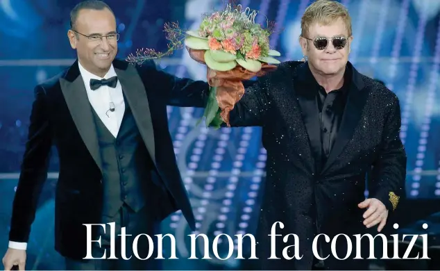  ??  ?? Fiori Il cantante Elton John (68 anni) con il conduttore Paolo Conti (54) ieri sul palco dell’Ariston