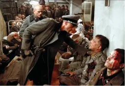  ?? ?? A scene from the film Downfall where SS-Brigadefuh­rer Wilhelm Mohnke comforts injured soldiers during the doomed defence of Berlin. (EOS & AF Archive)