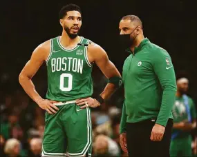  ?? Maddie Meyer / Getty Images ?? Celtics head coach Ime Udoka talks with Jayson Tatum during the first quarter of Game 2 of the Eastern Conference Semifinals at TD Garden on Tuesday in Boston.