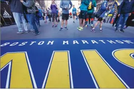  ?? AP PHOTO ?? People line up at the finish line at the Boston Marathon, which is being held today.