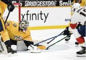  ?? MARK ZALESKI
AP ?? Predators goalie Pekka Rinne tries to cover up the puck as Panthers captain Aleksander Barkov moves in. Barkov had three assists in Thursday’s win at Nashville.