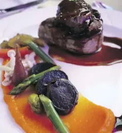  ?? ANDREA CHAN ?? Alberta Pork tenderloin medallions and braised cheek with pickled vegetables served at the gala dinner.