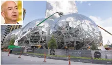  ?? THE ASSOCIATED PRESS PHOTOS ?? Constructi­on, right, continues in April on three large, glass-covered domes as part of an expansion of the Amazon.com campus in downtown Seattle. Cities nationwide are trying to woo Jeff Bezos, inset, in a race for Amazon’s second headquarte­rs.