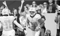  ?? ?? Dolphins wide receiver Mack Hollins celebrates after scoring a touchdown against the Giants during the first half at Hard Rock Stadium on Sunday.