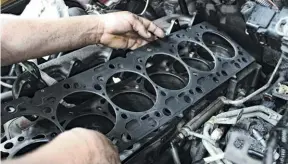  ??  ?? After the block’s deck had been cleaned up and wiped spotless, an OEM four-layer MLS head gasket from Cummins was set in place. However, in order to accommodat­e the steel fire-rings, the factory head gasket was void of its own firerings.