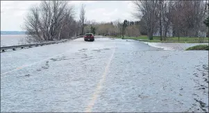  ?? CP PHOTO ?? New Brunswick Highway 105 south of Fredericto­n in Maugervill­e was closed to traffic except for local residents due to flooding from the St. John River on Sunday.