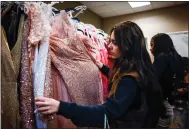  ?? ?? Niki Shiva, 18, of Hayward looks through dresses during a prom dress giveaway by the Princess Project Silicon Valley.