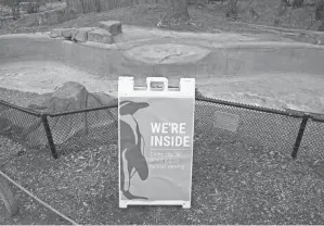  ?? ?? A sign is displayed near a Magellan penguin outdoor viewing area redirectin­g visitors on Tuesday at the Blank Park Zoo in Des Moines, Iowa.